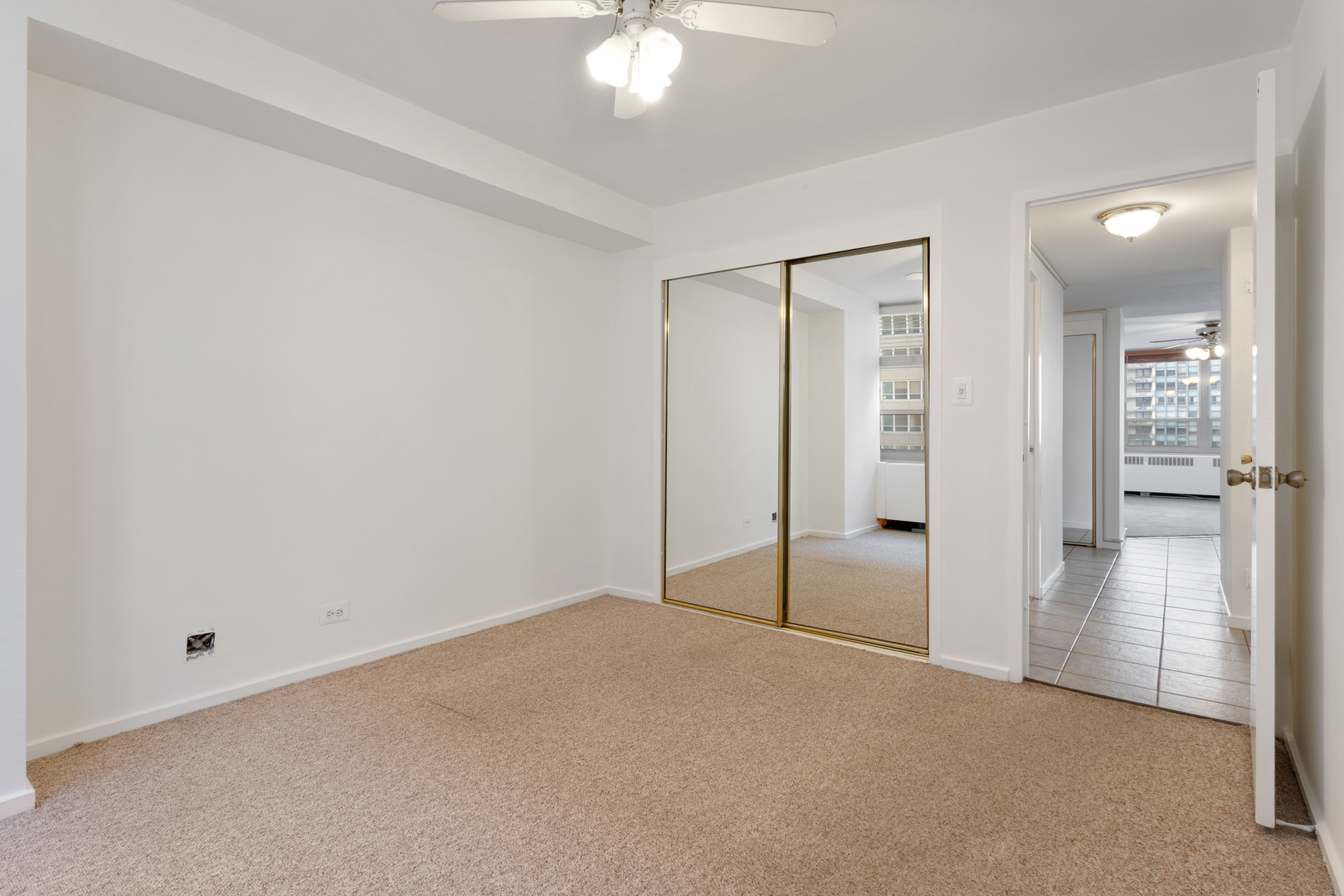 3950 North Lake Shore Drive, Unit 1006B Chicago, IL 60613 - Photo 12 of 12 wooden floor in an empty room