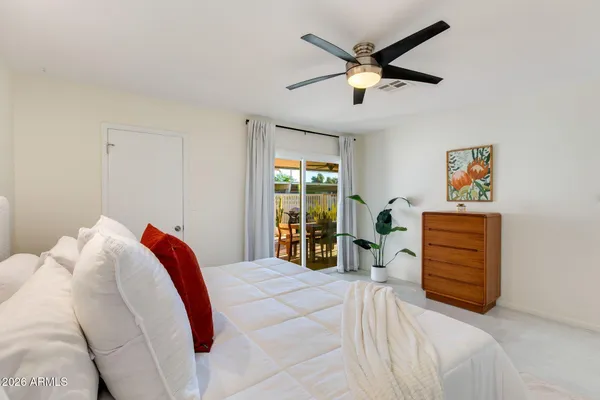a bedroom with a bed and a large window
