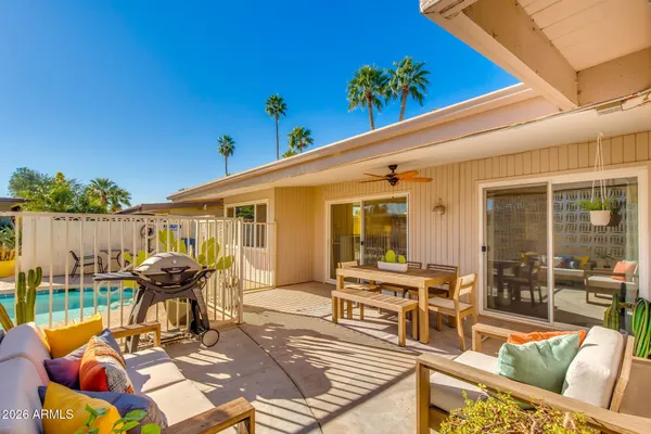 a view of a patio with a table and chairs