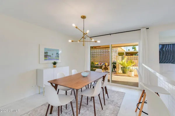 a living room with furniture and large windows