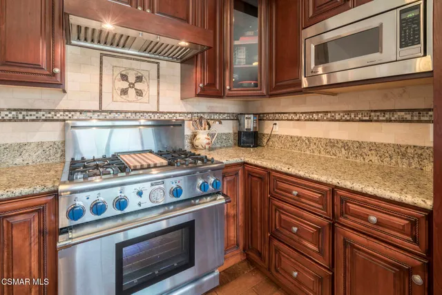 a view of balcony with furniture and umbrella