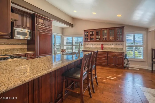 a dining room with furniture a chandelier and wooden floor