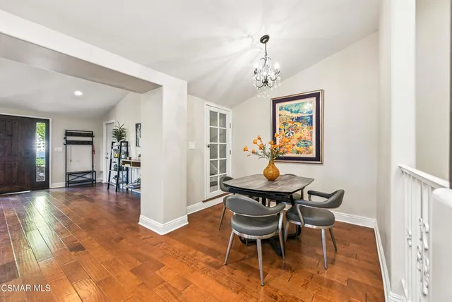 a bedroom with a large bed and a wooden floor