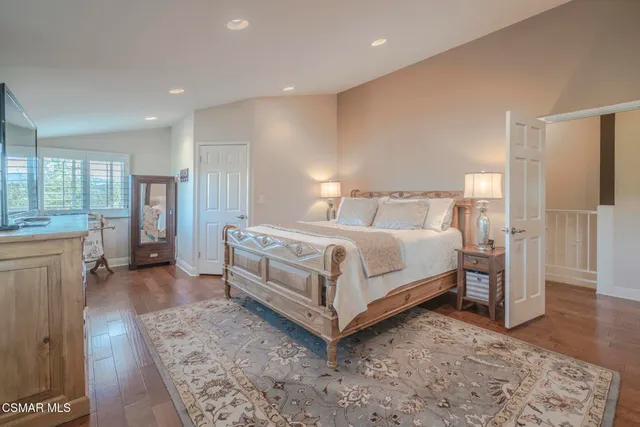 a bedroom with a bed and a mirror