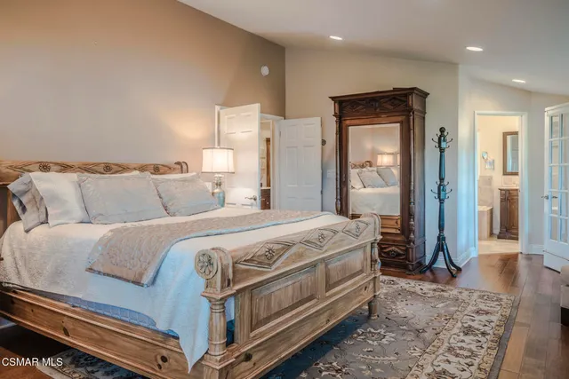 a spacious bathroom with a tub sink and mirror