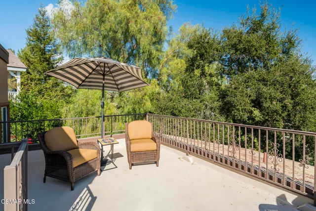 a view of a patio with table and chairs and potted plants