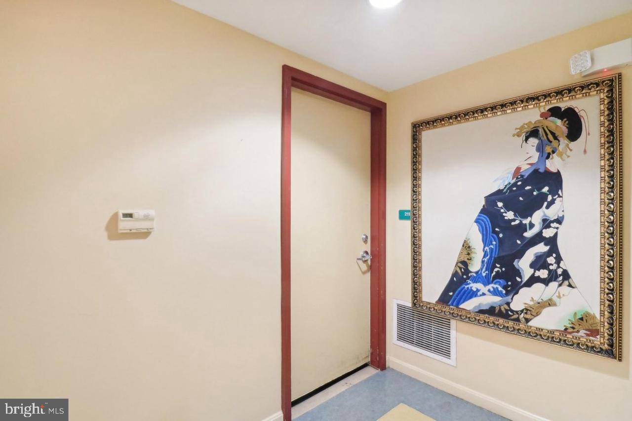 7981 Eastern Avenue Northwest, Unit 211 Silver Spring, MD 20910 - Photo 27 of 50 a view of a hallway with painted walls