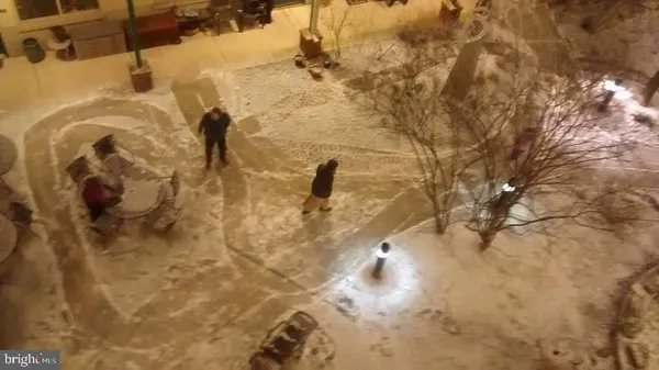 a living room with hardwood floor and a large window