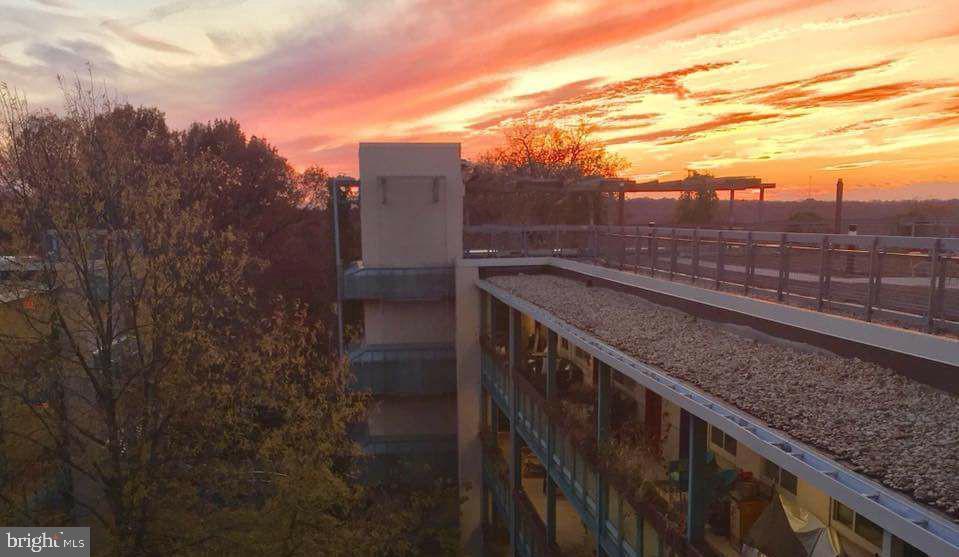 7981 Eastern Avenue Northwest, Unit 211 Silver Spring, MD 20910 - Photo 41 of 49 Sunset hues over modern architecture.