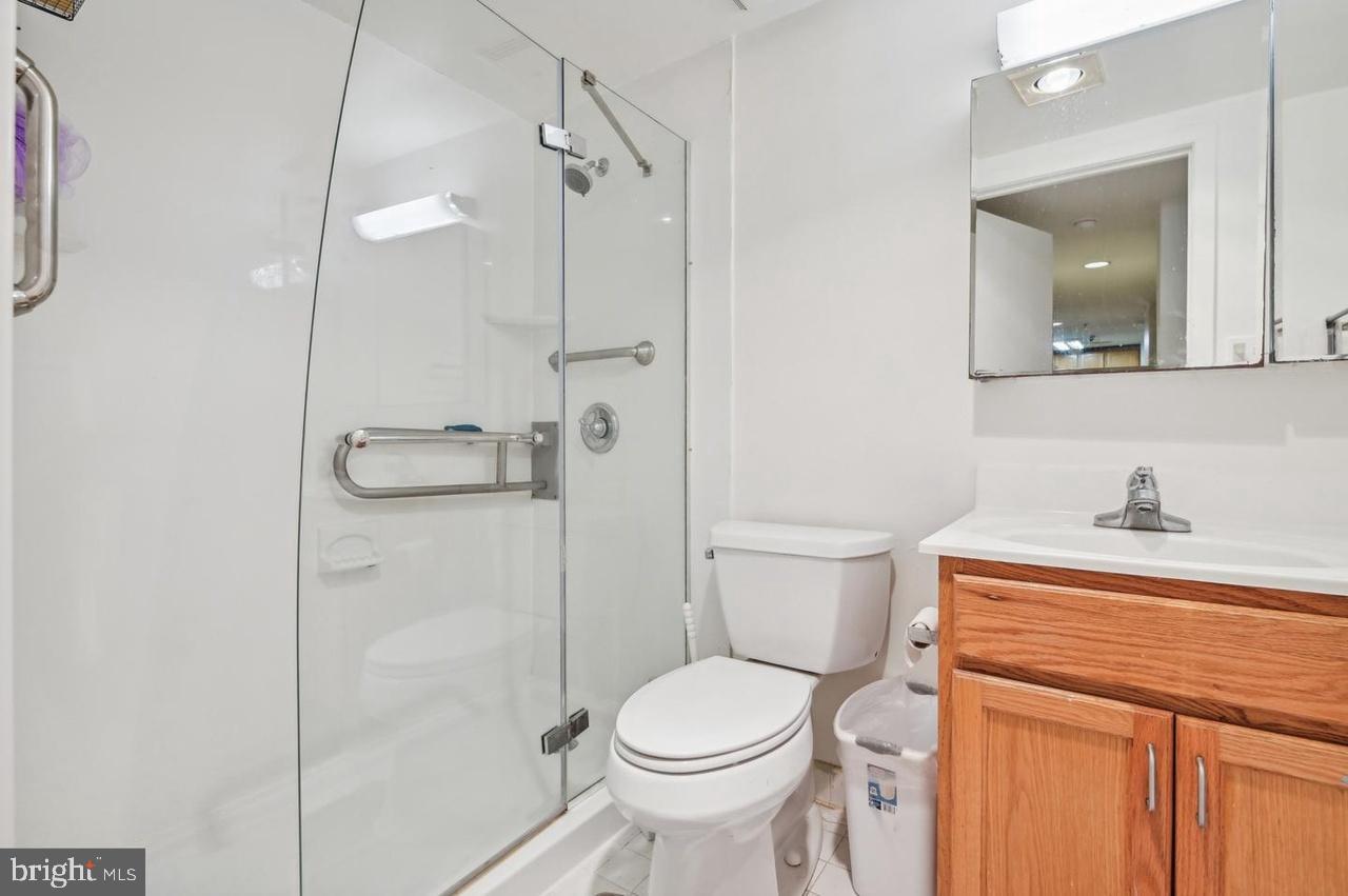 7981 Eastern Avenue Northwest, Unit 211 Silver Spring, MD 20910 - Photo 43 of 50 a bathroom with a sink a toilet and shower