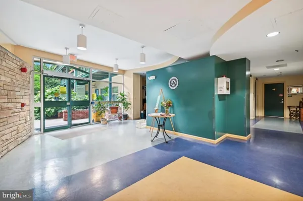 a living room with furniture large window and a fireplace