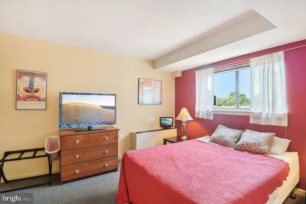 a bed room with a bed and a chair