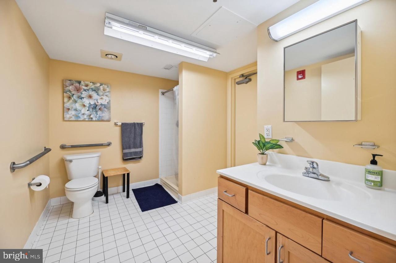 7981 Eastern Avenue Northwest, Unit 211 Silver Spring, MD 20910 - Photo 48 of 50 a bathroom with a sink and a mirror