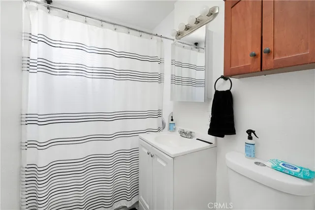 a bathroom with a sink and a white cabinet