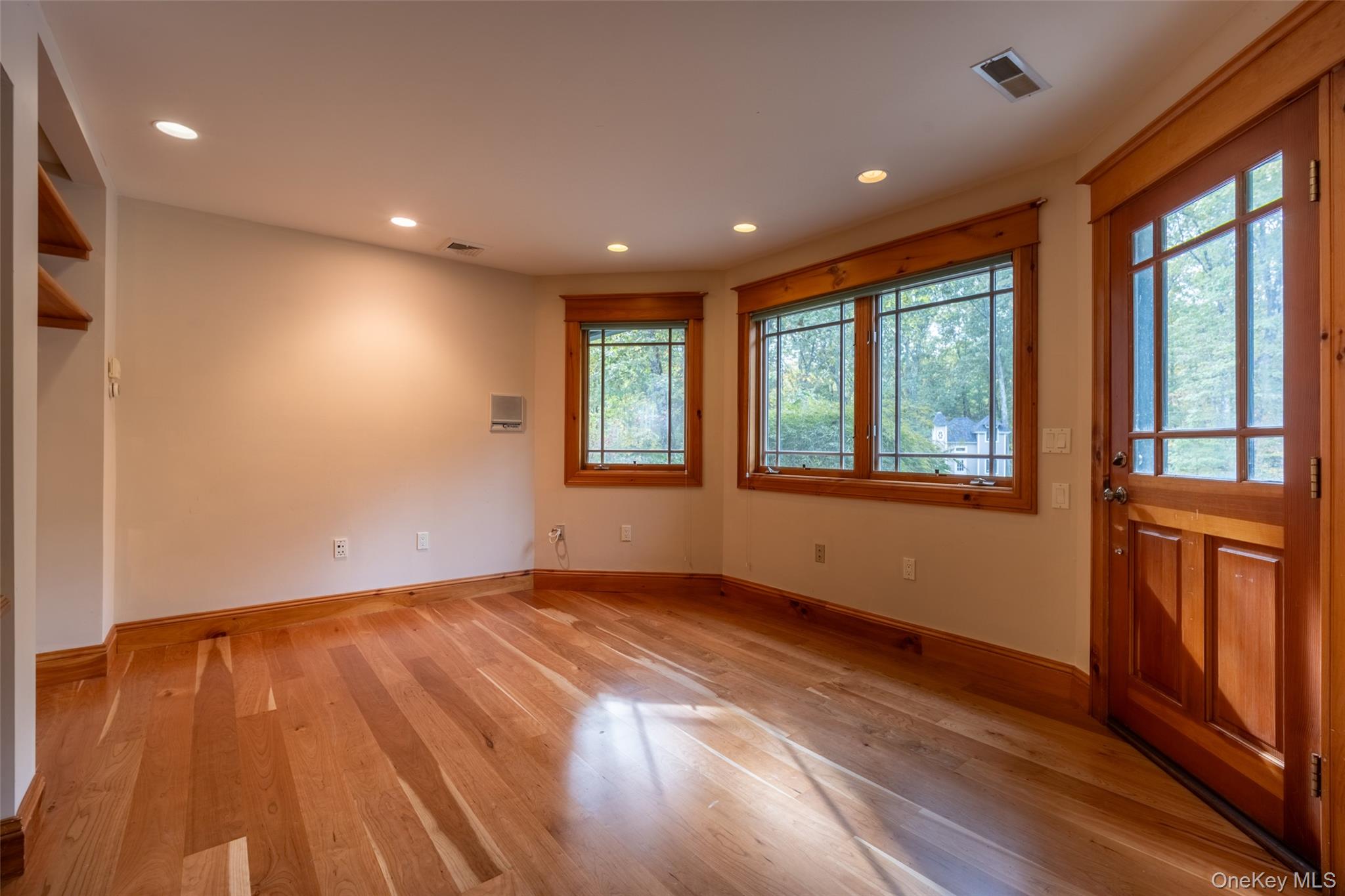 243 Hawleys Corners Road Highland, NY 12528 - Photo 13 of 44 a view of an empty room with wooden floor and a window