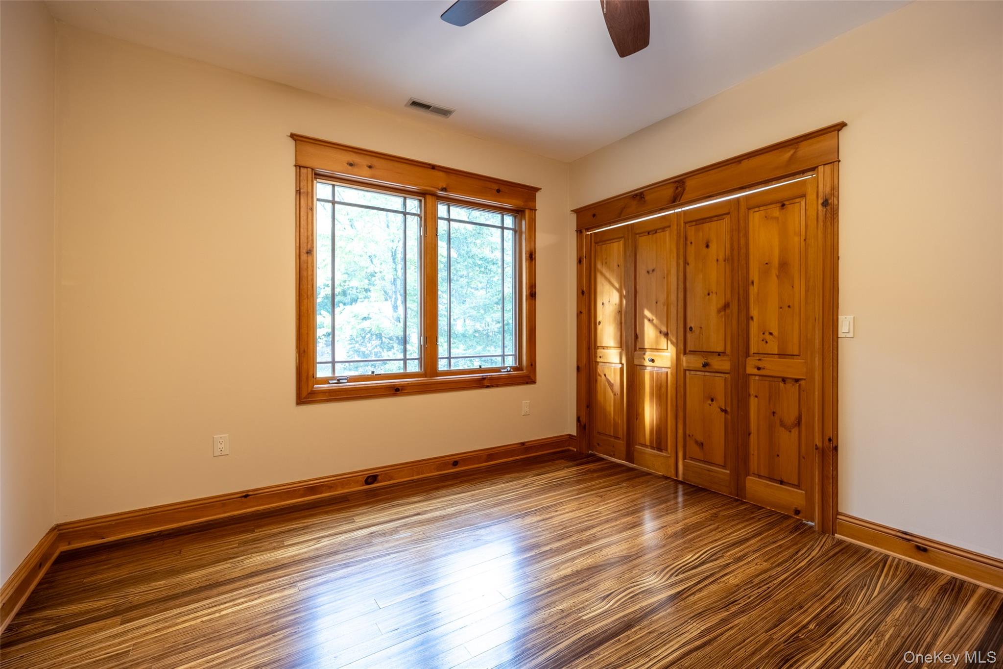 243 Hawleys Corners Road Highland, NY 12528 - Photo 24 of 44 an empty room with wooden floor and windows