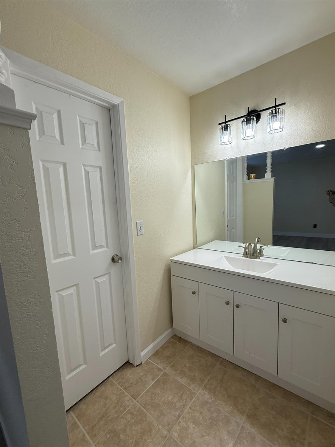 1909 Wagner Heights Road Stockton, CA 95209 - Photo 11 of 12 a bathroom with a double vanity sink and a mirror