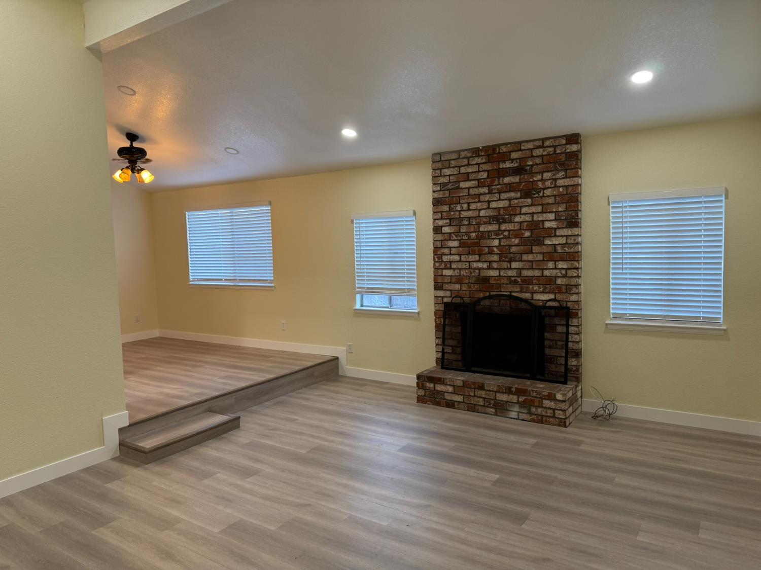 1909 Wagner Heights Road Stockton, CA 95209 - Photo 2 of 12 a living room with hard wood floors and a fireplace