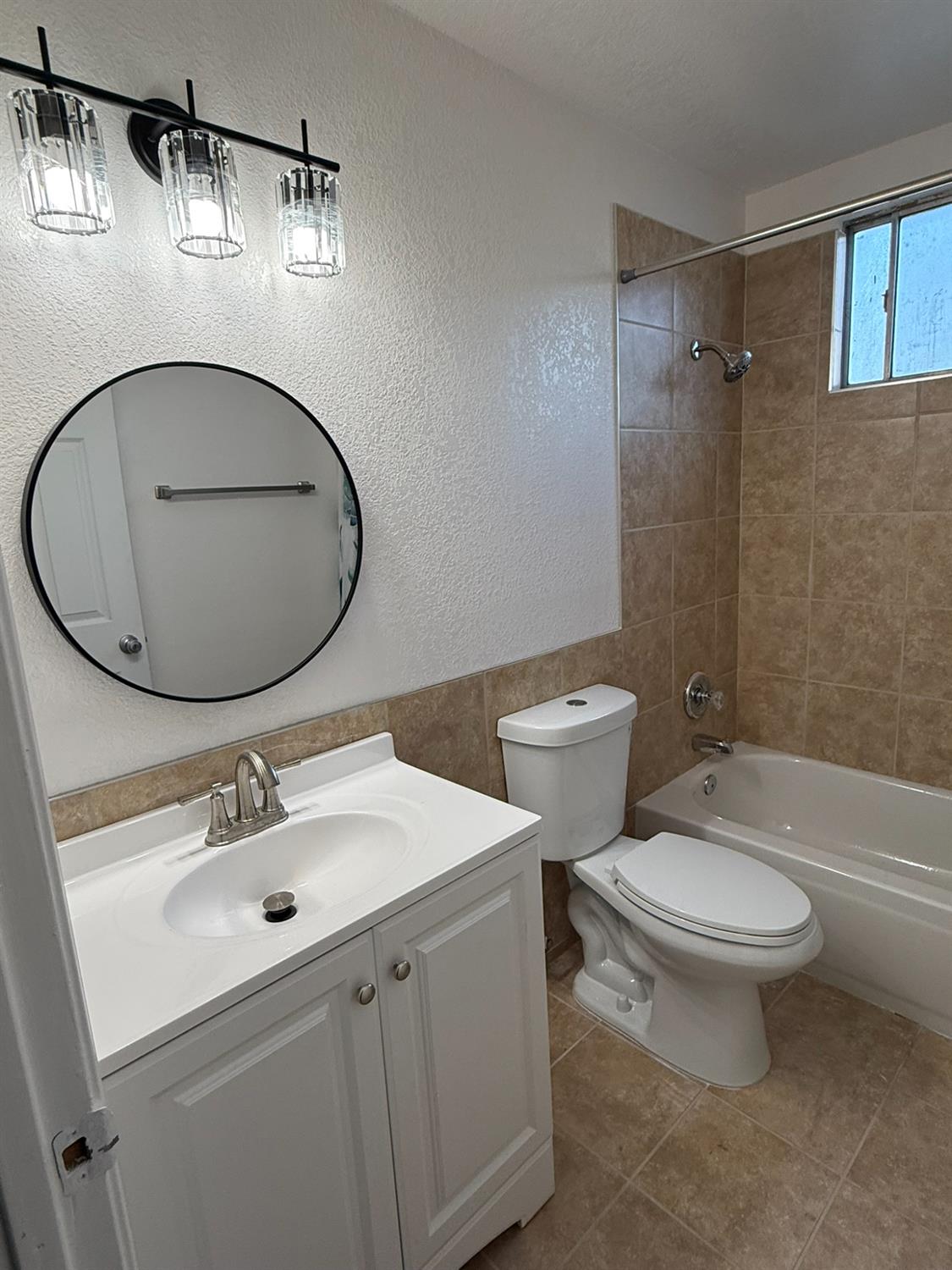 1909 Wagner Heights Road Stockton, CA 95209 - Photo 3 of 12 a bathroom with a toilet a sink and mirror