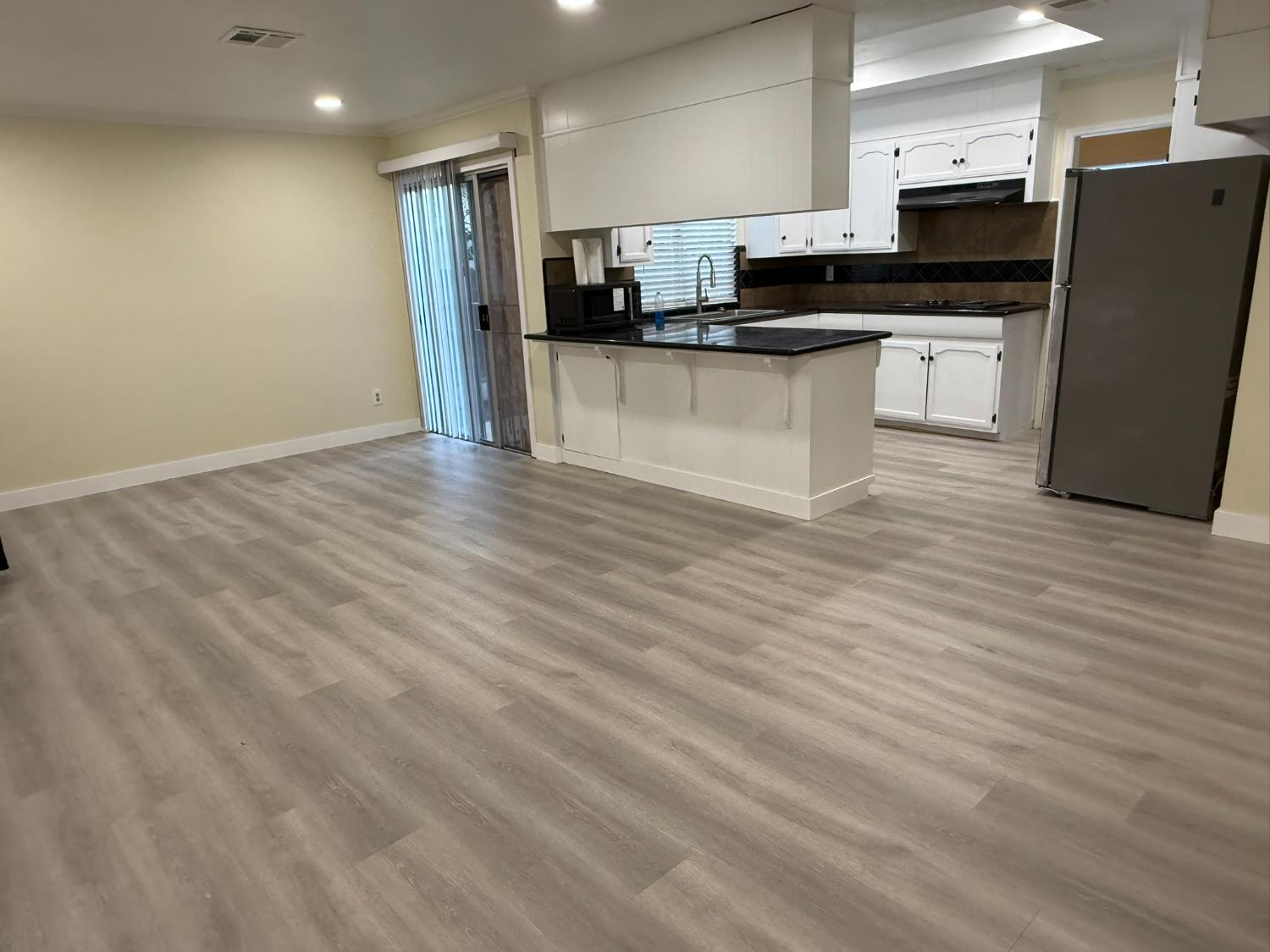 1909 Wagner Heights Road Stockton, CA 95209 - Photo 7 of 12 a kitchen with stainless steel appliances granite countertop a refrigerator and a stove top oven