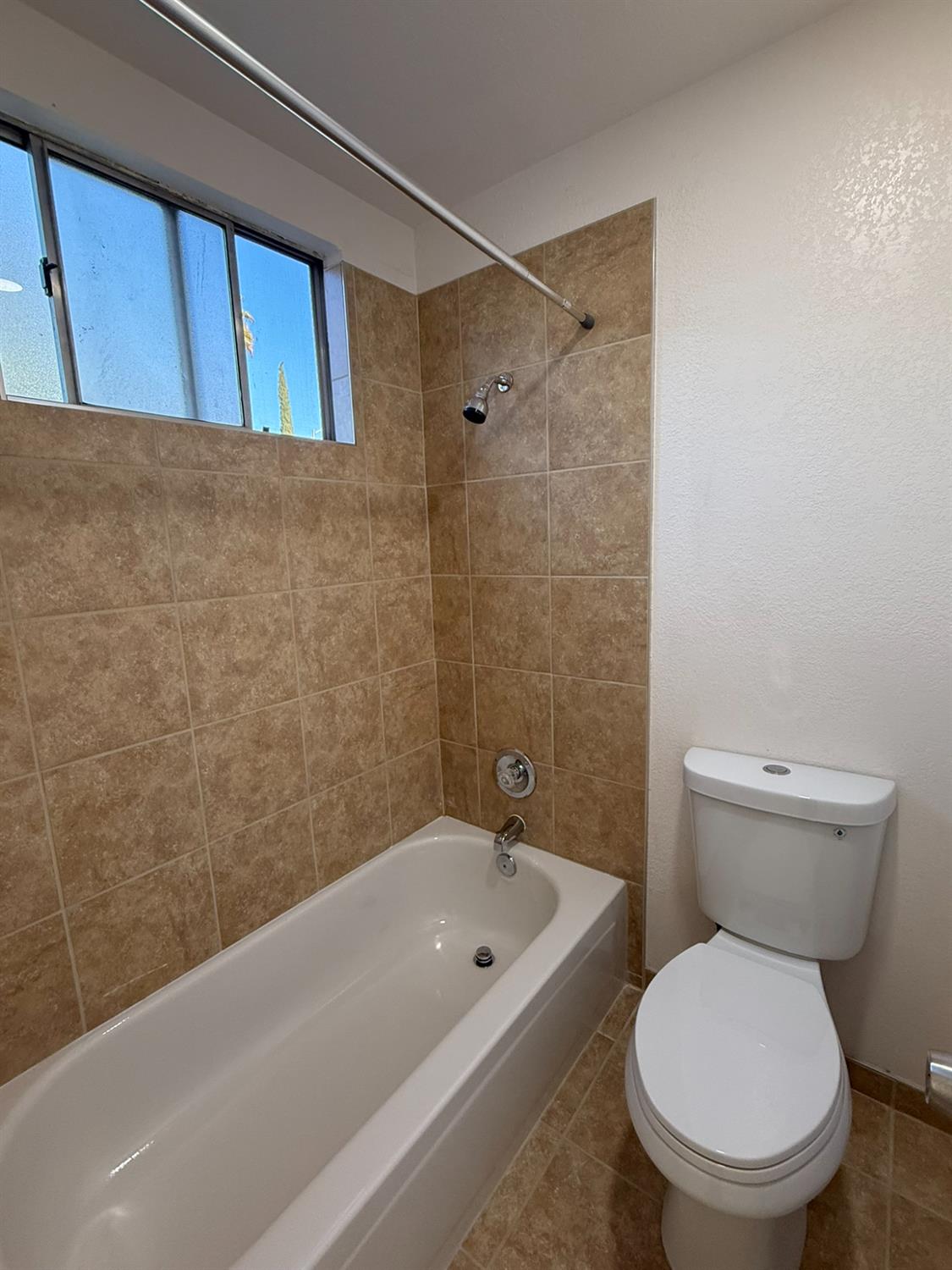 1909 Wagner Heights Road Stockton, CA 95209 - Photo 10 of 12 a bathroom with a toilet and a bathtub