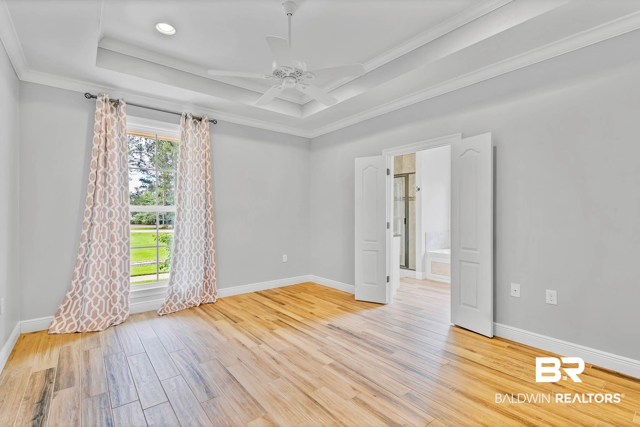8145 Bay View Drive Foley, AL 36535 - Photo 27 of 81 Primary Bedroom with wood tiled finished floors, crown molding, a raised ceiling, and ceiling fan