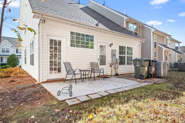 a view of a dinning table and chairs in patio of the house