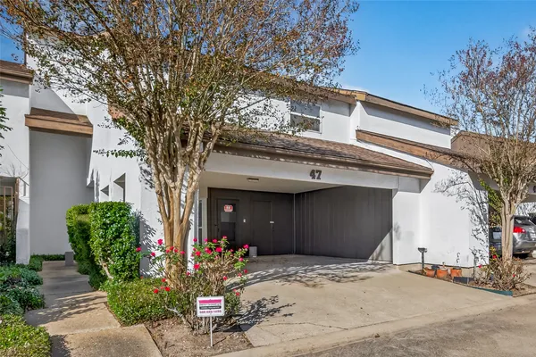 a front view of a house with lots of trees