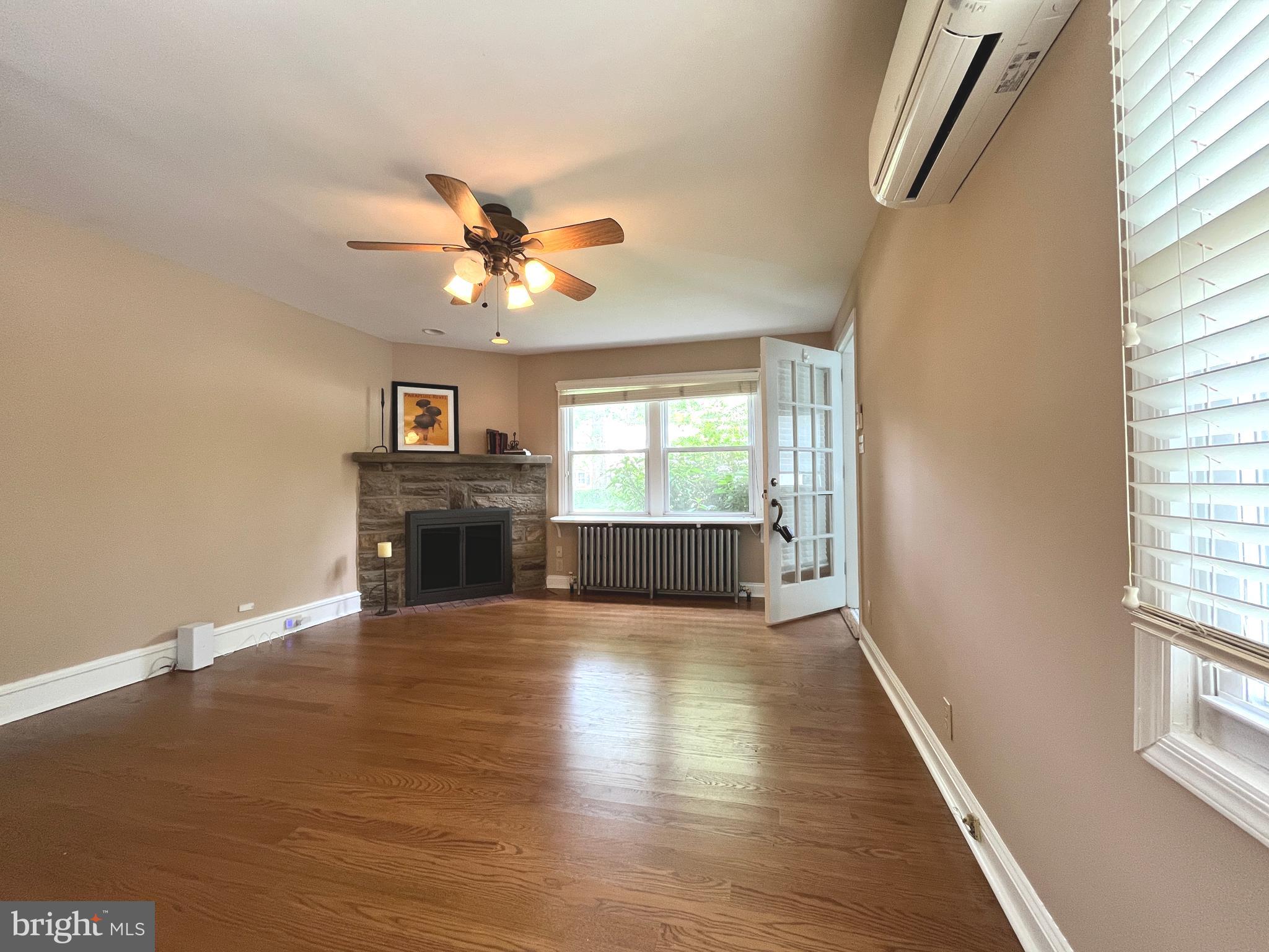 434 St Davids Avenue Wayne, PA 19087 - Photo 4 of 23 wooden floor in an empty room with a window and a kitchen