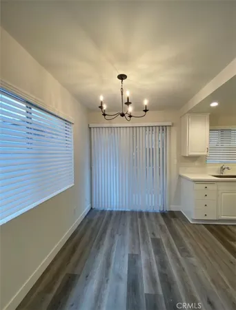 a view of a kitchen with wooden floor