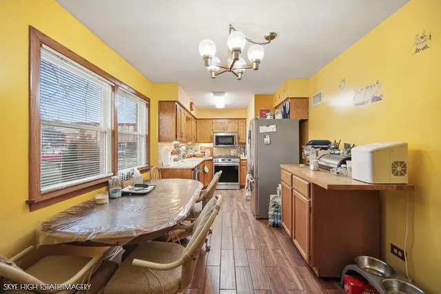 a dining room with granite countertop furniture and wooden floor