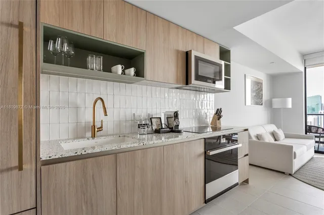 a kitchen with stainless steel appliances granite countertop a sink and stove top oven