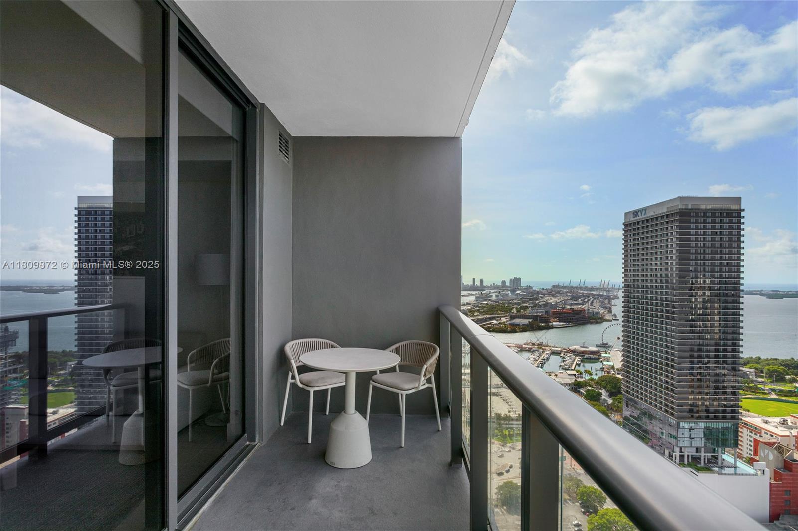 601 Northeast 1st Street, Unit 3907 Miami, FL 33132 - Photo 4 of 13 a view of a balcony with chairs