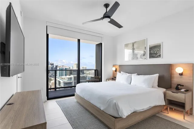 a bedroom with a large bed and a window