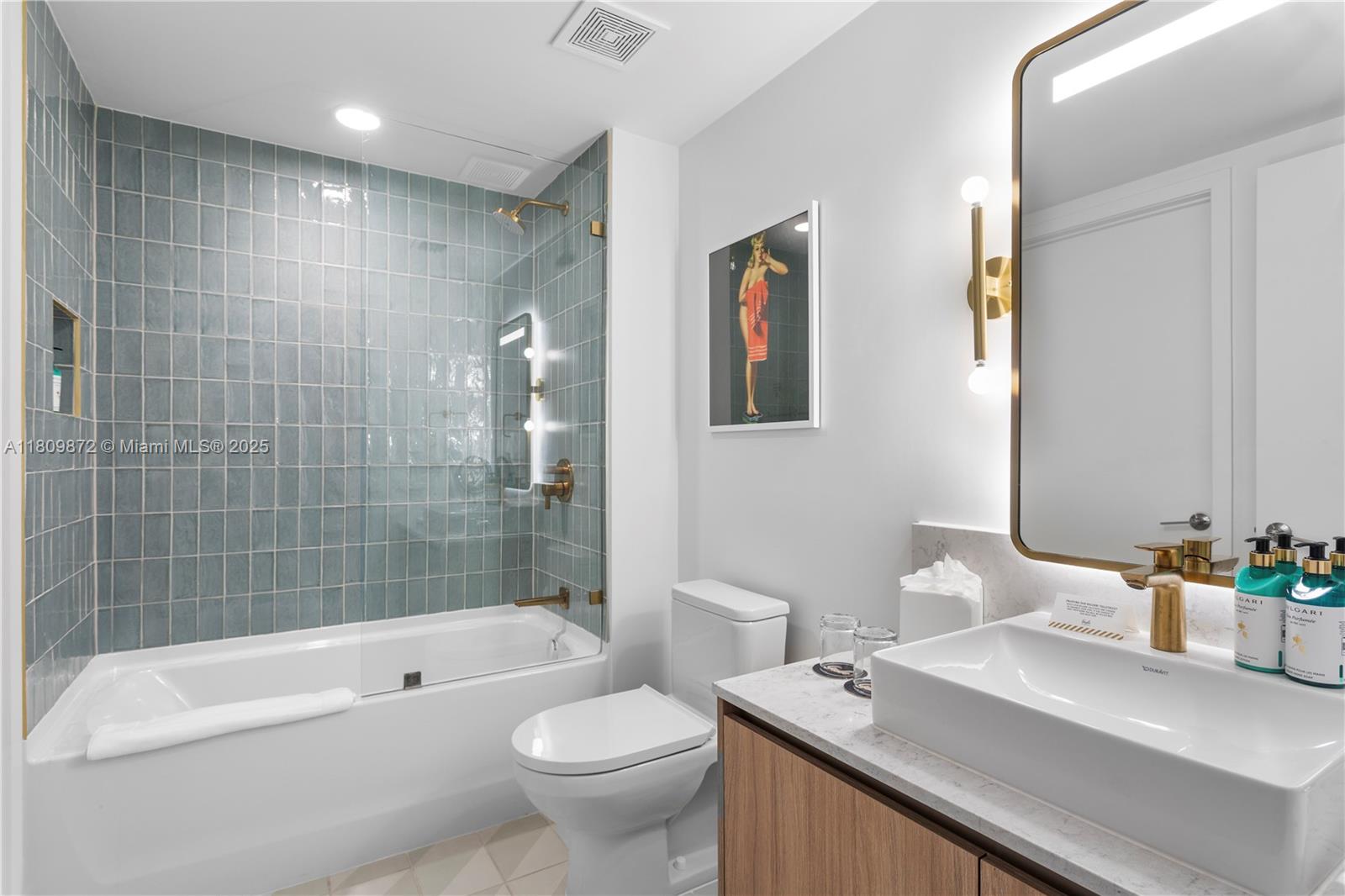 601 Northeast 1st Street, Unit 3907 Miami, FL 33132 - Photo 9 of 13 a bathroom with a sink a toilet and shower