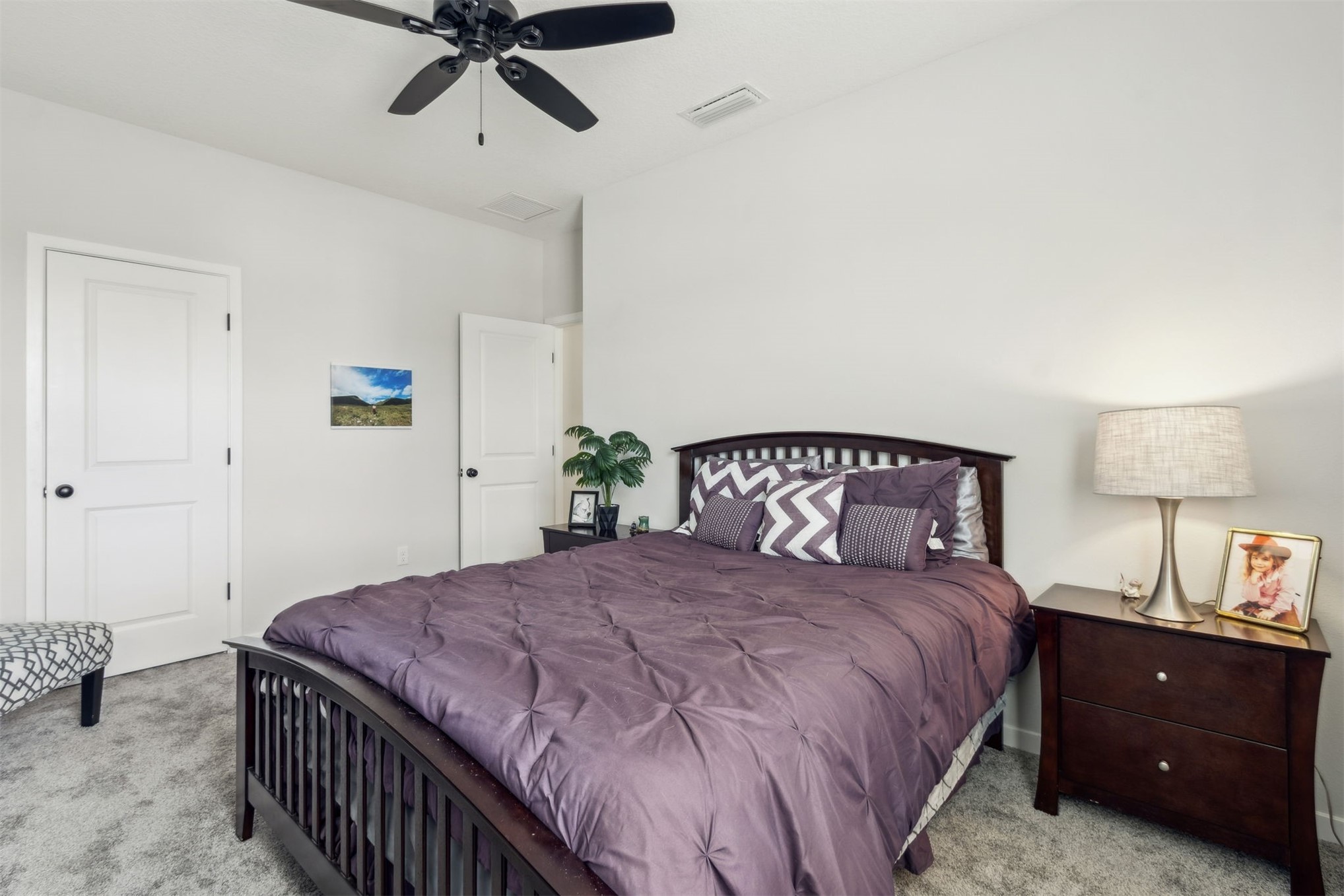 96277 Broadmoore Road Fernandina Beach, FL 32034 - Photo 20 of 26 a bedroom with a bed and a lamp on the dresser