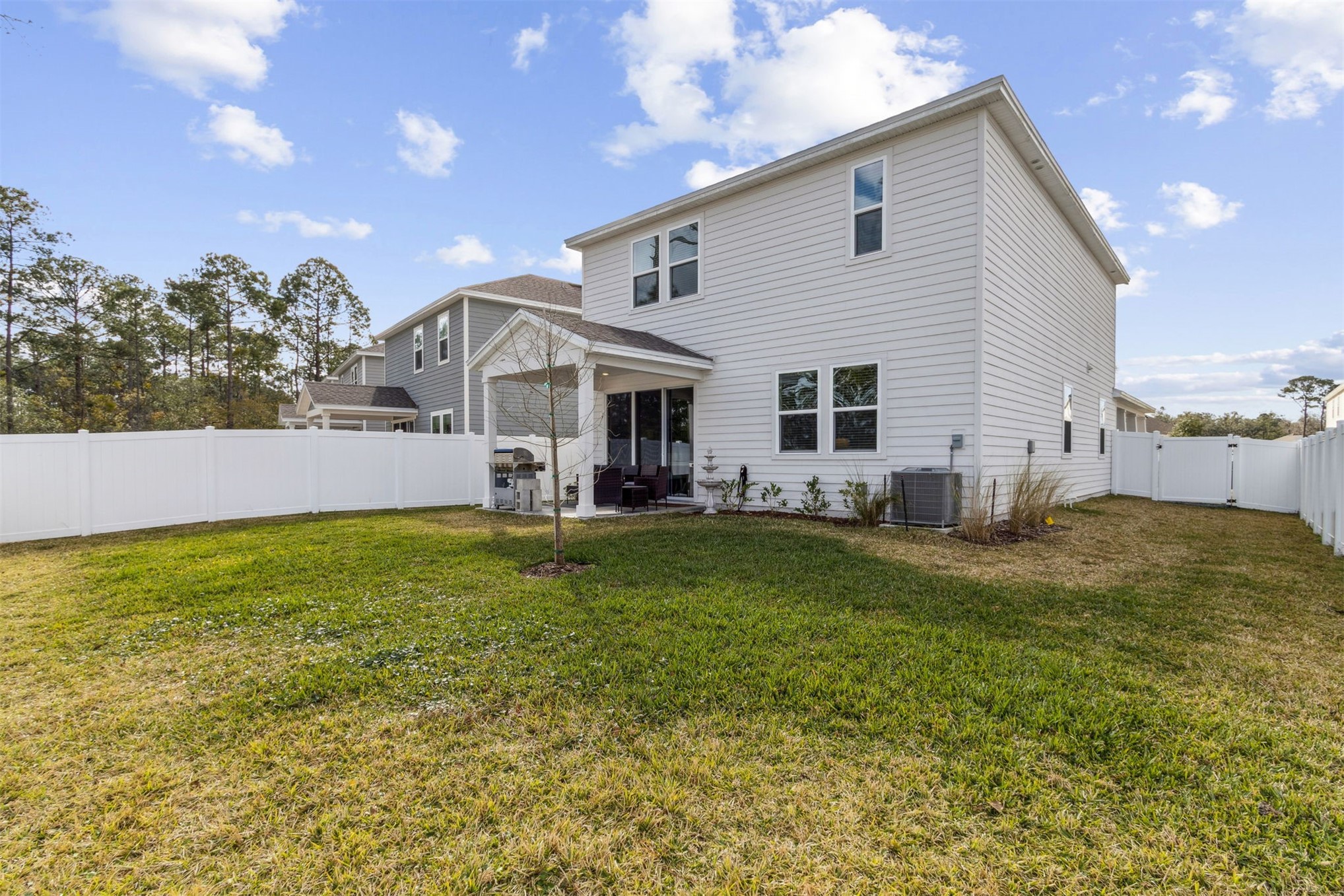 96277 Broadmoore Road Fernandina Beach, FL 32034 - Photo 24 of 26 a view of a house with a yard patio and swimming pool