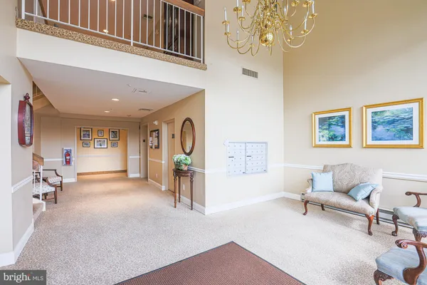 a living room with furniture a window and a chandelier