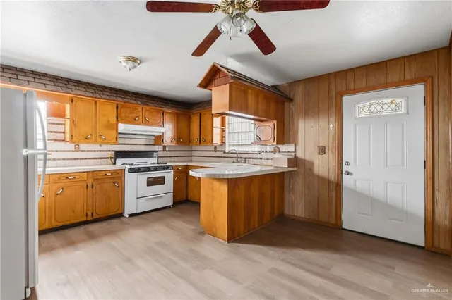 a kitchen with stainless steel appliances granite countertop a refrigerator a sink and dishwasher