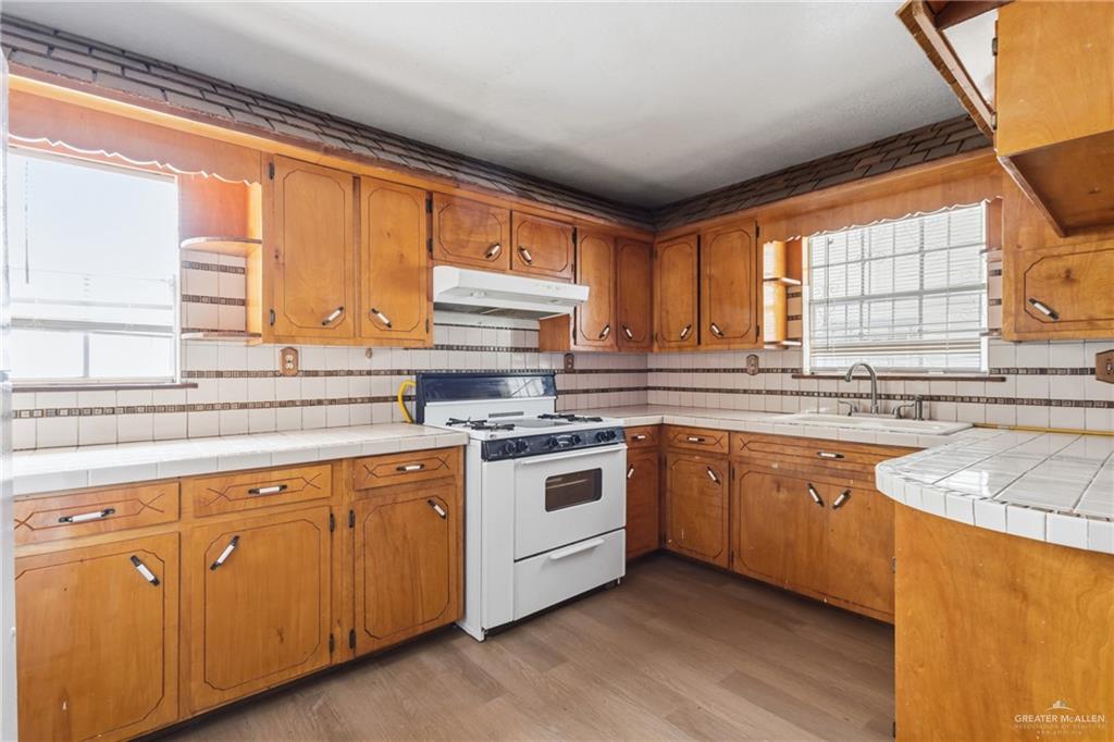 101 Ash Street Donna, TX 78537 - Photo 6 of 14 a kitchen with stainless steel appliances granite countertop a sink a stove a refrigerator and cabinets