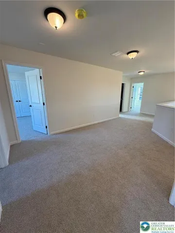 an empty room with windows and entrance