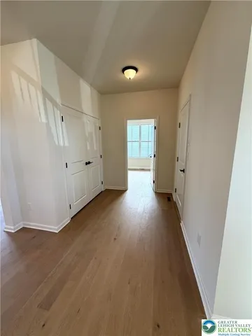 a view of a livingroom with wooden floor and a window