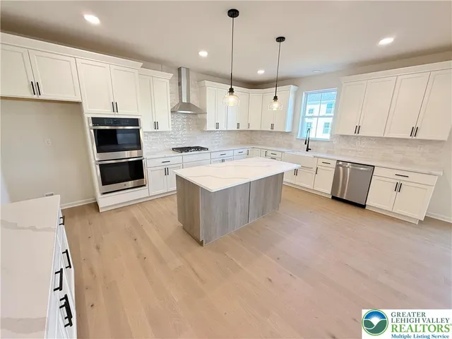 a kitchen with a stove top oven sink and cabinets