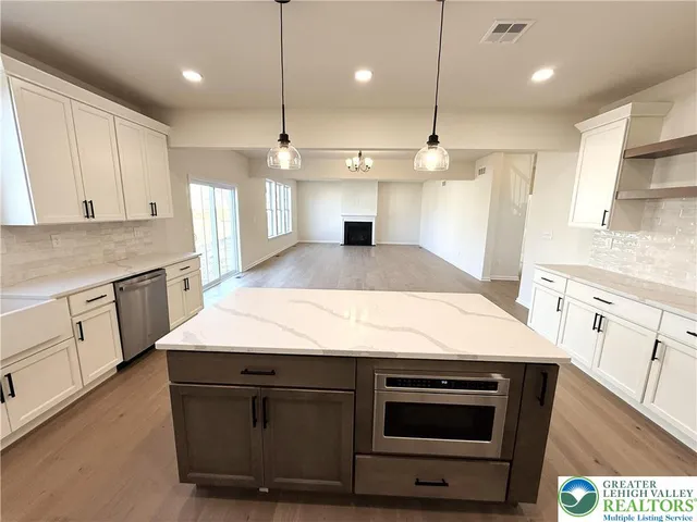 a large kitchen with a stove and a sink