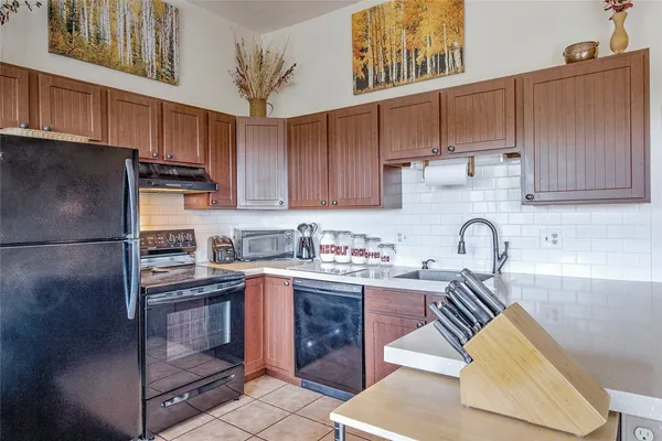 a kitchen with stainless steel appliances granite countertop a refrigerator sink and cabinets