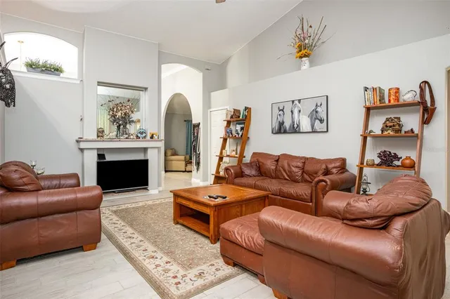 a living room with furniture a fireplace and a window