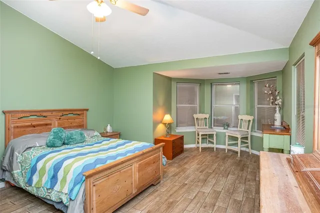 a bedroom with a bed and a large window