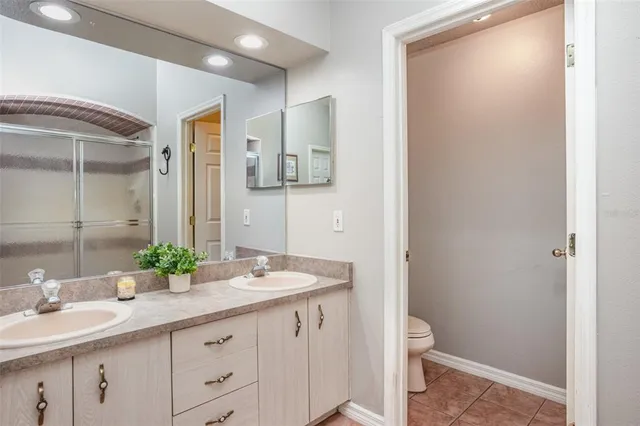 a bathroom with a double vanity sink and mirror