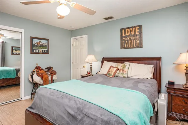 a bedroom with bed and wooden floor