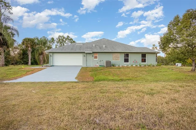 a front view of house with yard and trees